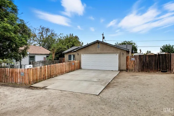 a backyard of a house with wooden fence