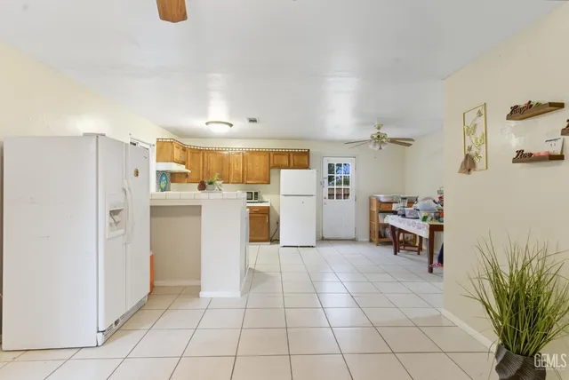a kitchen with stainless steel appliances a refrigerator and a cabinets