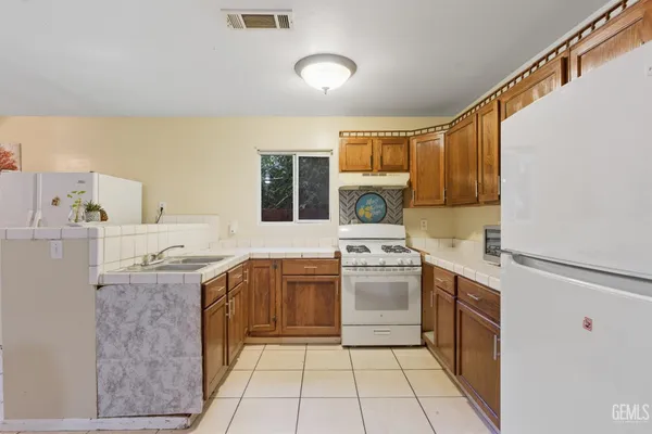 a kitchen with a stove top oven sink and cabinets