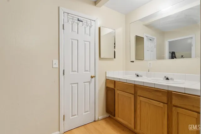 a bathroom with a double vanity sink and mirror
