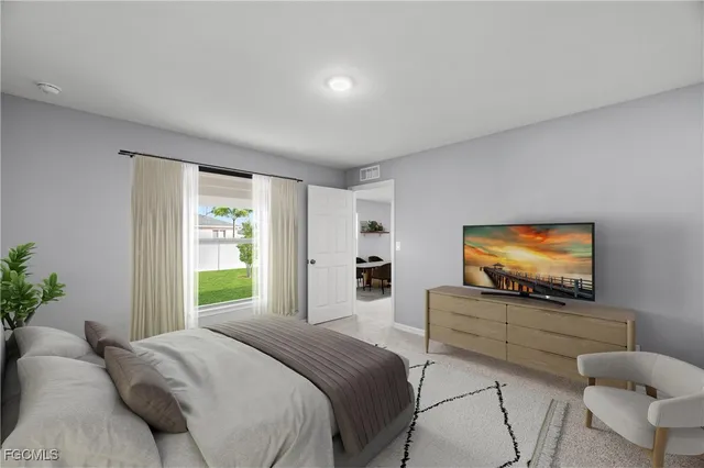 a bedroom with a bed and a flat screen television