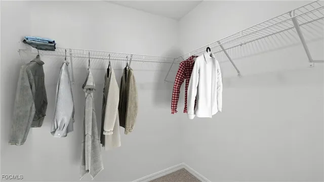 a view of walk in closet with clothes