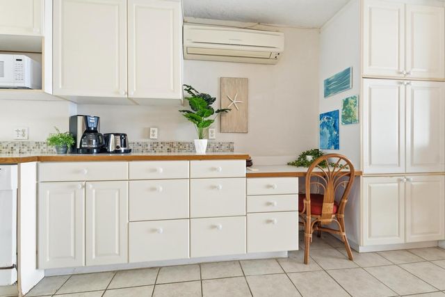 a kitchen with a sink appliances and cabinets