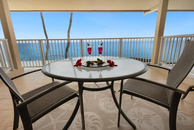 a dining room with furniture a chandelier and wooden floor