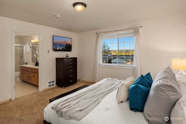 a bedroom with a bed and a television