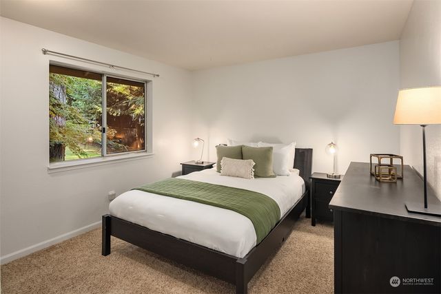 a bedroom with a bed a lamp and a window