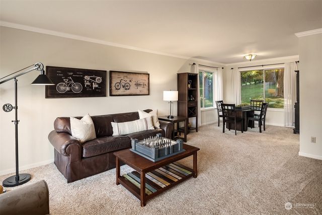 a living room with furniture and large windows