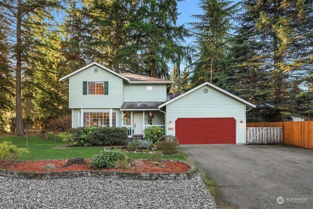 a view of a house with a yard and garage