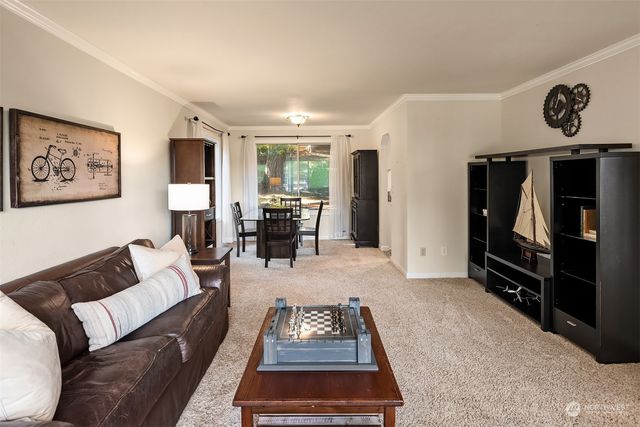 a living room with furniture a rug and a flat screen tv