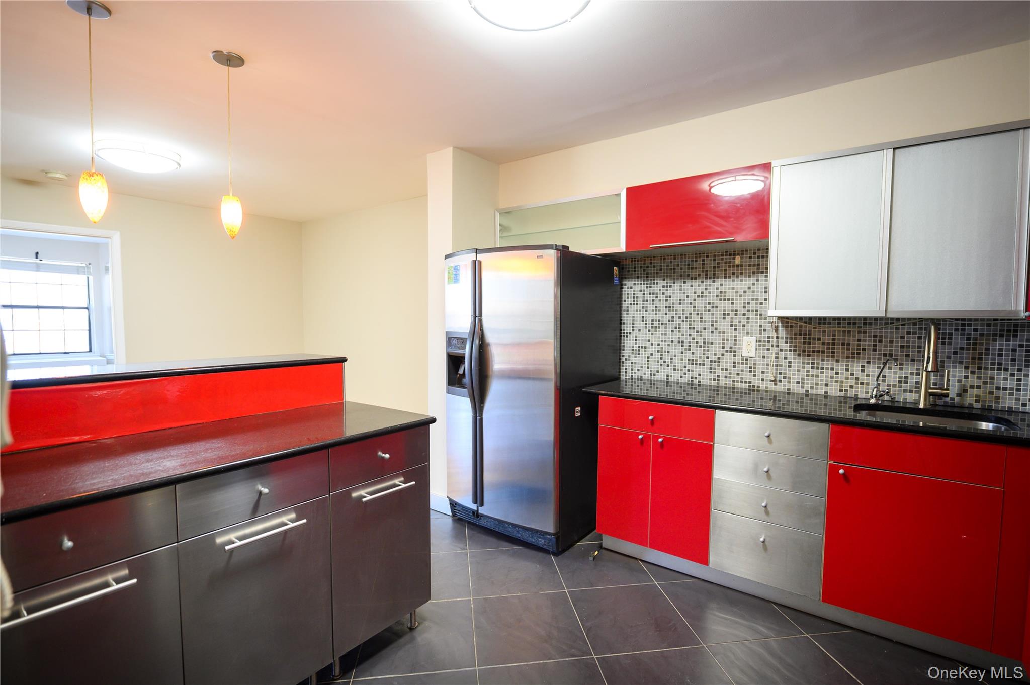 7124 164th Street, Unit 2 Queens, NY 11365 - Photo 12 of 22 a kitchen with stainless steel appliances granite countertop a refrigerator and a stove