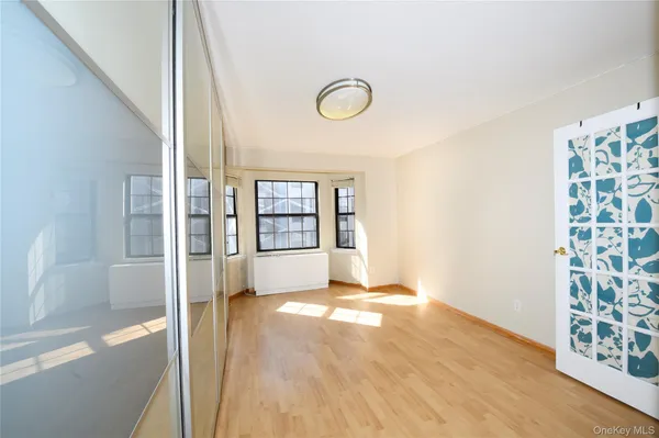 a view of an empty room with glass door and a window