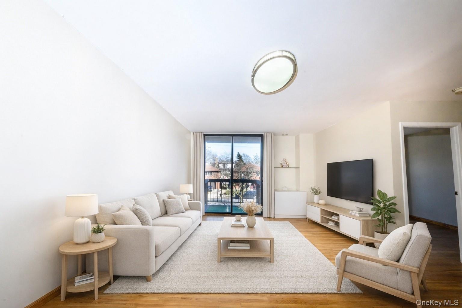 7124 164th Street, Unit 2 Queens, NY 11365 - Photo 2 of 22 a living room with furniture and a flat screen tv