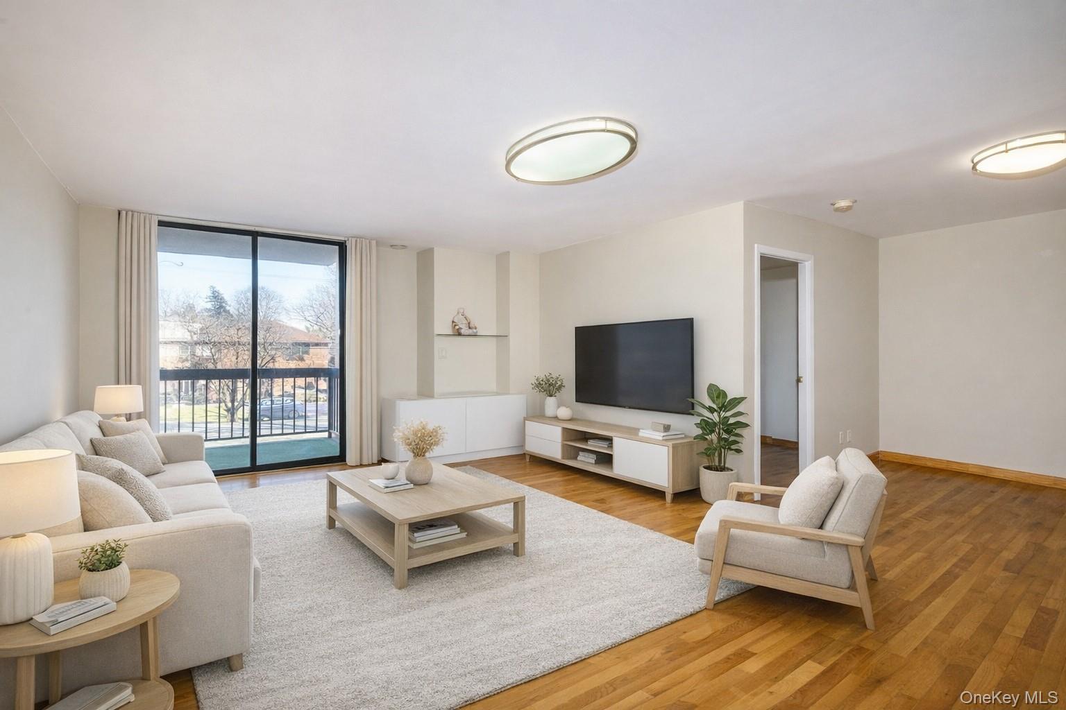 7124 164th Street, Unit 2 Queens, NY 11365 - Photo 4 of 22 a living room with furniture and a flat screen tv