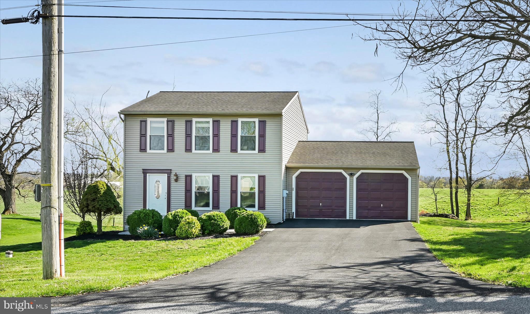 a front view of a house with a garden and yard