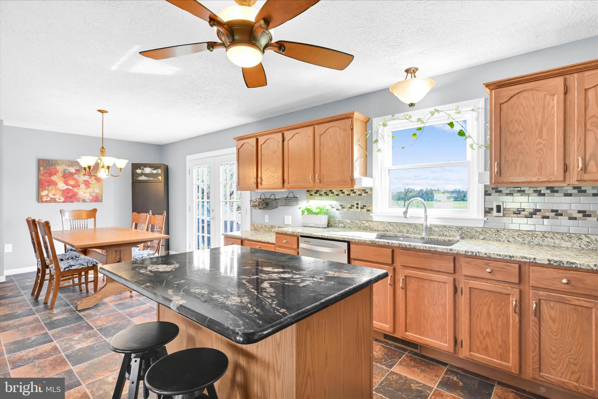 4285 Highland Road Elizabethtown, PA 17022 - Photo 14 of 39 a kitchen with granite countertop a table chairs sink and cabinets