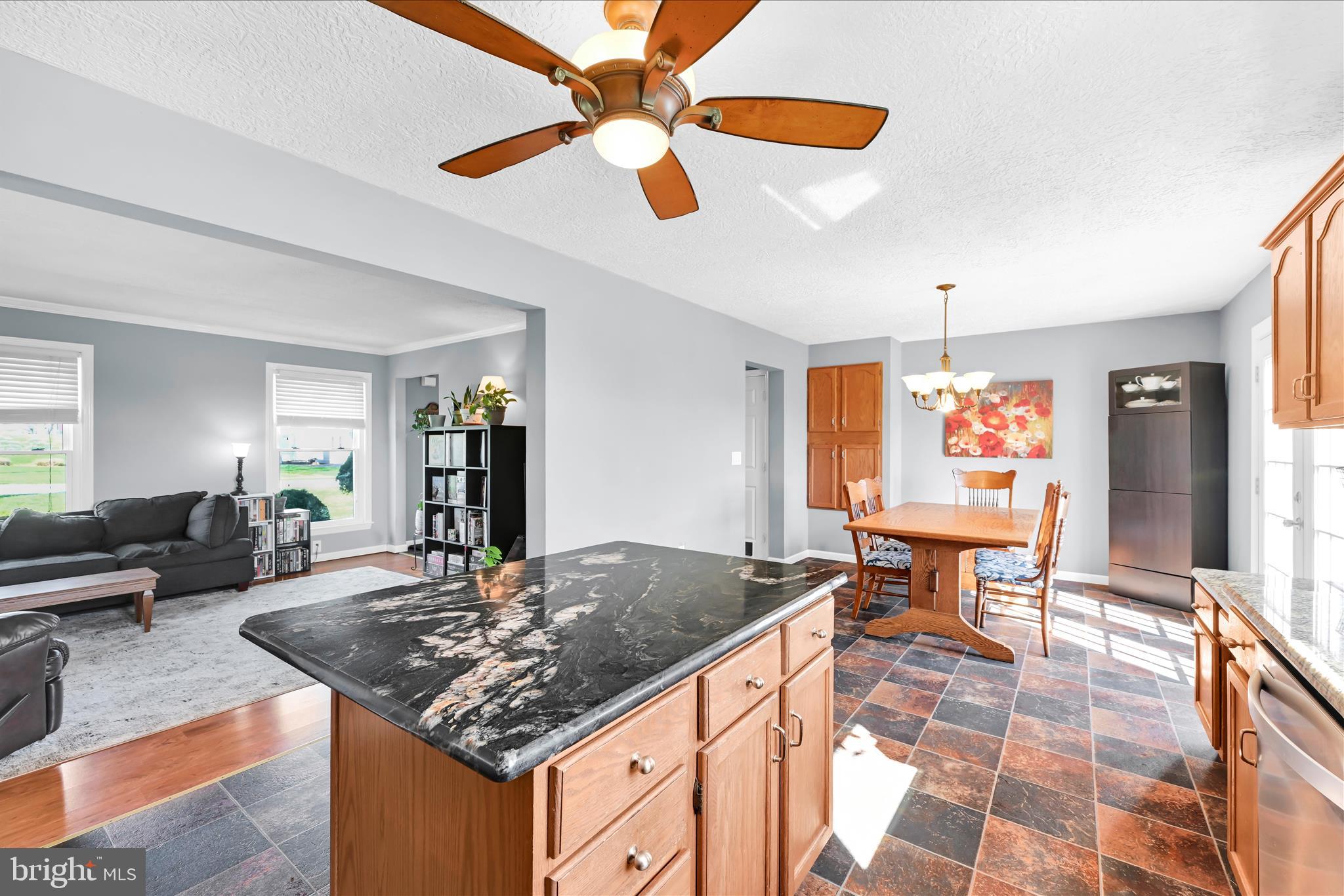 4285 Highland Road Elizabethtown, PA 17022 - Photo 15 of 39 a kitchen with stainless steel appliances granite countertop a dining table and chairs in it