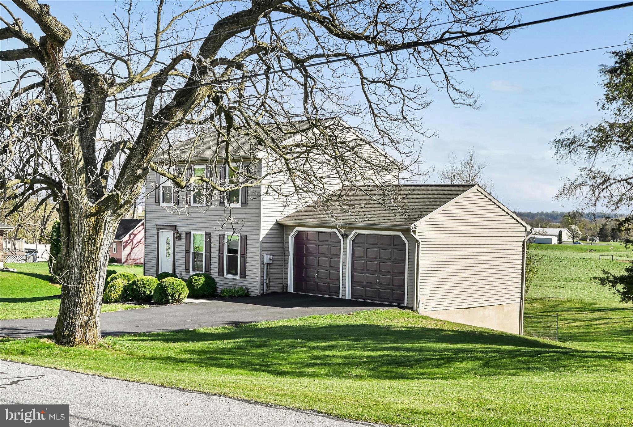 4285 Highland Road Elizabethtown, PA 17022 - Photo 3 of 39 a front view of a house with a garden and trees
