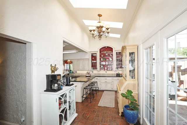 a bathroom with a sink a toilet and a large mirror