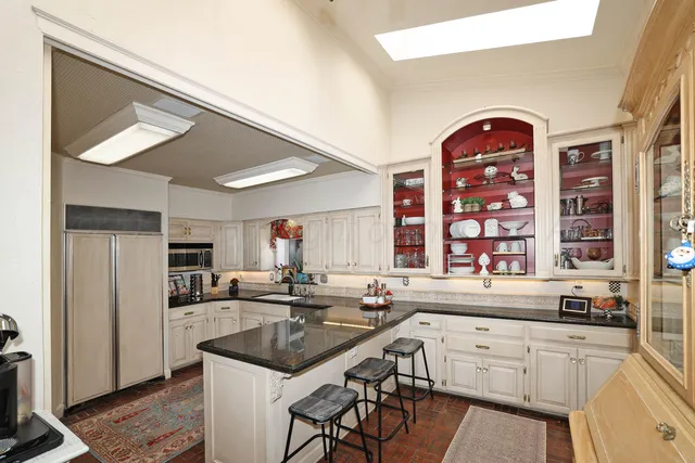 a bathroom with a sink a toilet and a large mirror