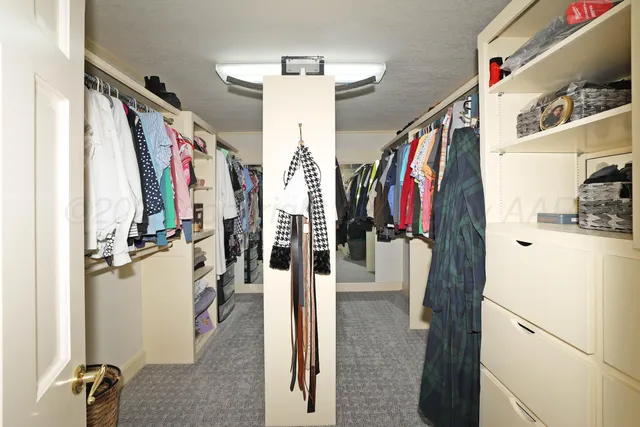 a view of a patio with table and chairs potted plants and large tree