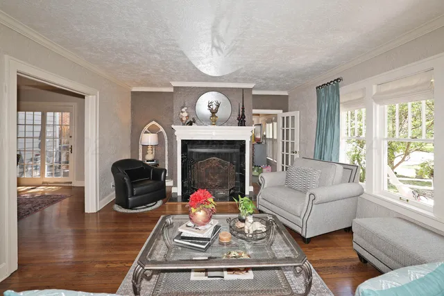 a view of a dining room with furniture a chandelier and a window