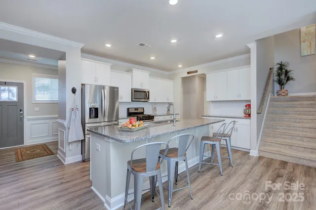 a view of kitchen with refrigerator microwave and wooden floor