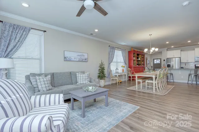 a living room with furniture and kitchen view