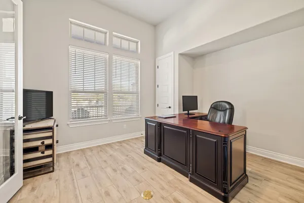 a living room with furniture and a view of kitchen
