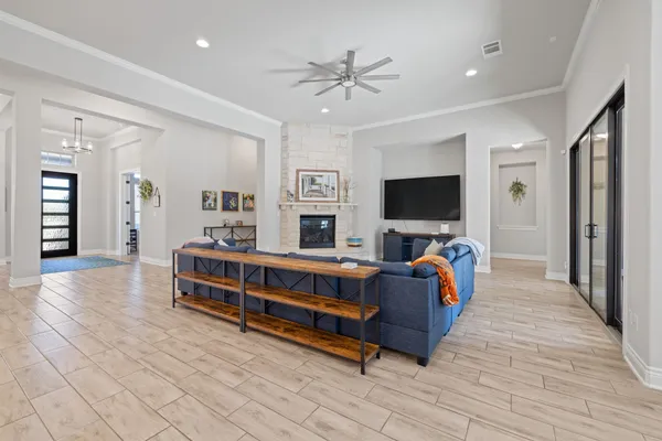 a living room with furniture and a chandelier
