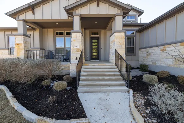 a view of a room that has a large window and a hallway