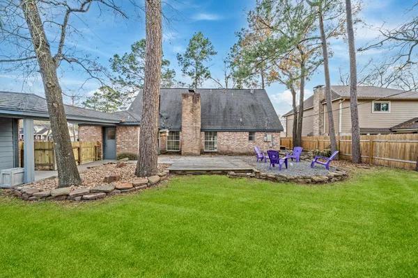 a view of a house with backyard and sitting area