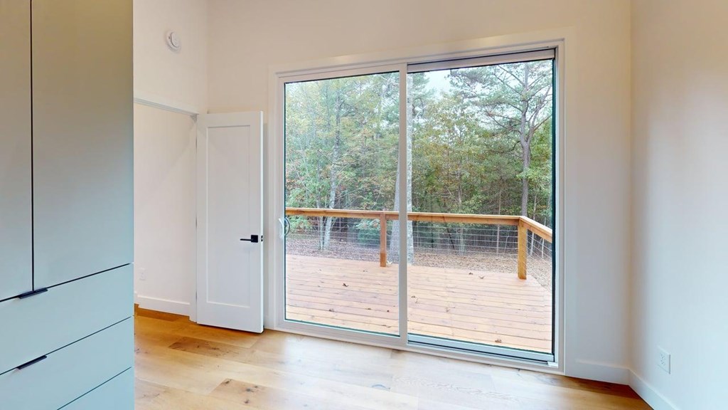 433 Brannon Ridge Young Harris, GA 30582 - Photo 11 of 13 an empty room with wooden floor and windows