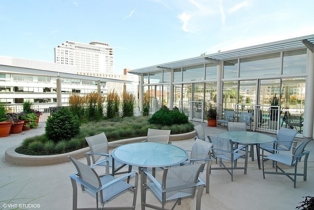 1640 Maple Avenue, Unit 1606 Evanston, IL 60201 - Photo 39 of 40 a view of a patio with table and chairs and potted plants