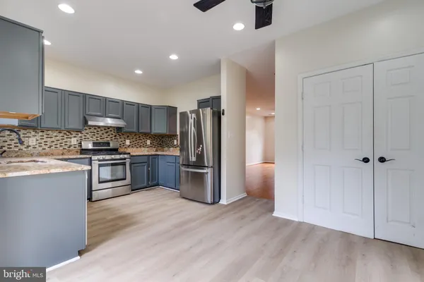 a kitchen with a refrigerator and a sink