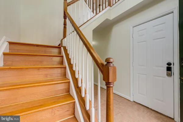 a view of staircase with railing and white walls