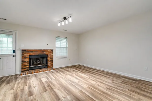 a view of empty room with fireplace and fan