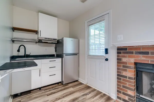 a kitchen with a sink and a refrigerator