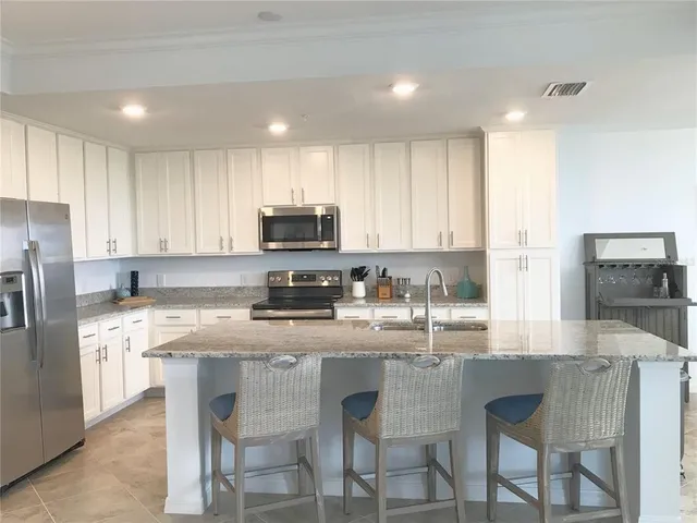 a living room with furniture a flat screen tv and a large window