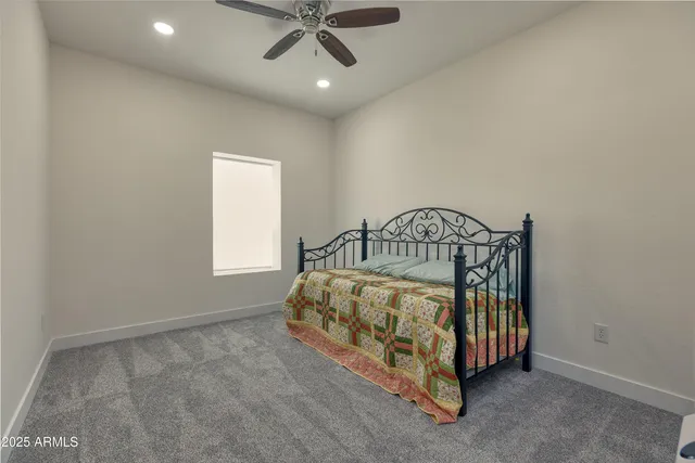 a bedroom with a bed and window