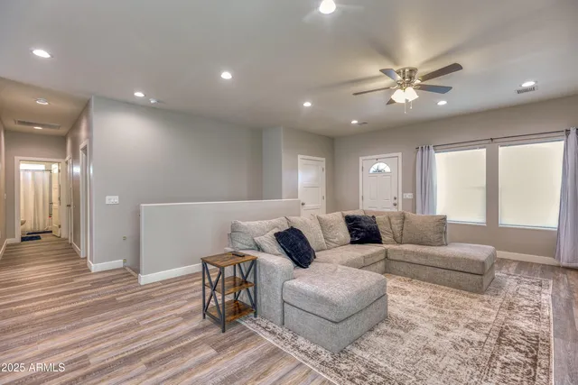 a living room with furniture and wooden floor