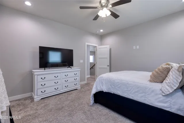 a bedroom with a bed and flat screen tv
