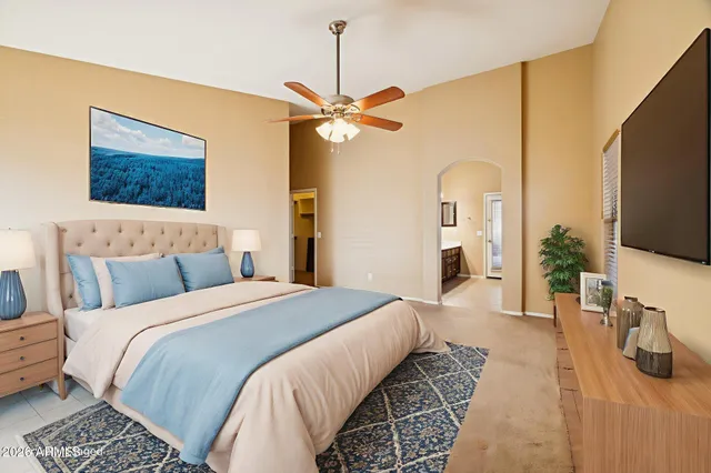 a bedroom with a bed dresser and flat screen tv