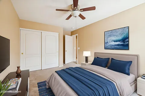 a bedroom with bed and wooden floor