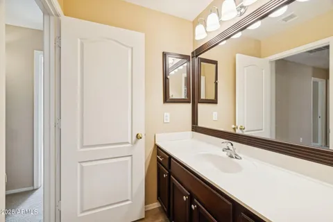 a bathroom with a double vanity sink and a mirror