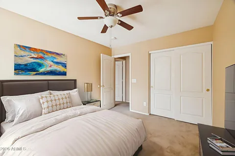 a bedroom with a bed and a painting on the wall