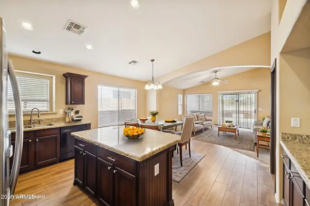 a view of living room with granite countertop a couch and wooden floor