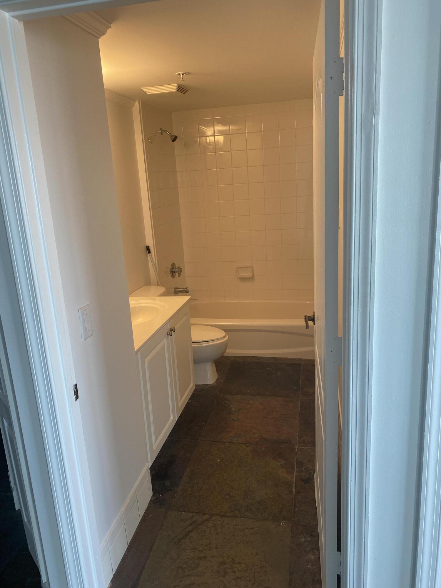 1627 Southwest 37th Avenue, Unit 1003 Miami, FL 33145 - Photo 11 of 12 a bathroom with a sink a toilet and shower