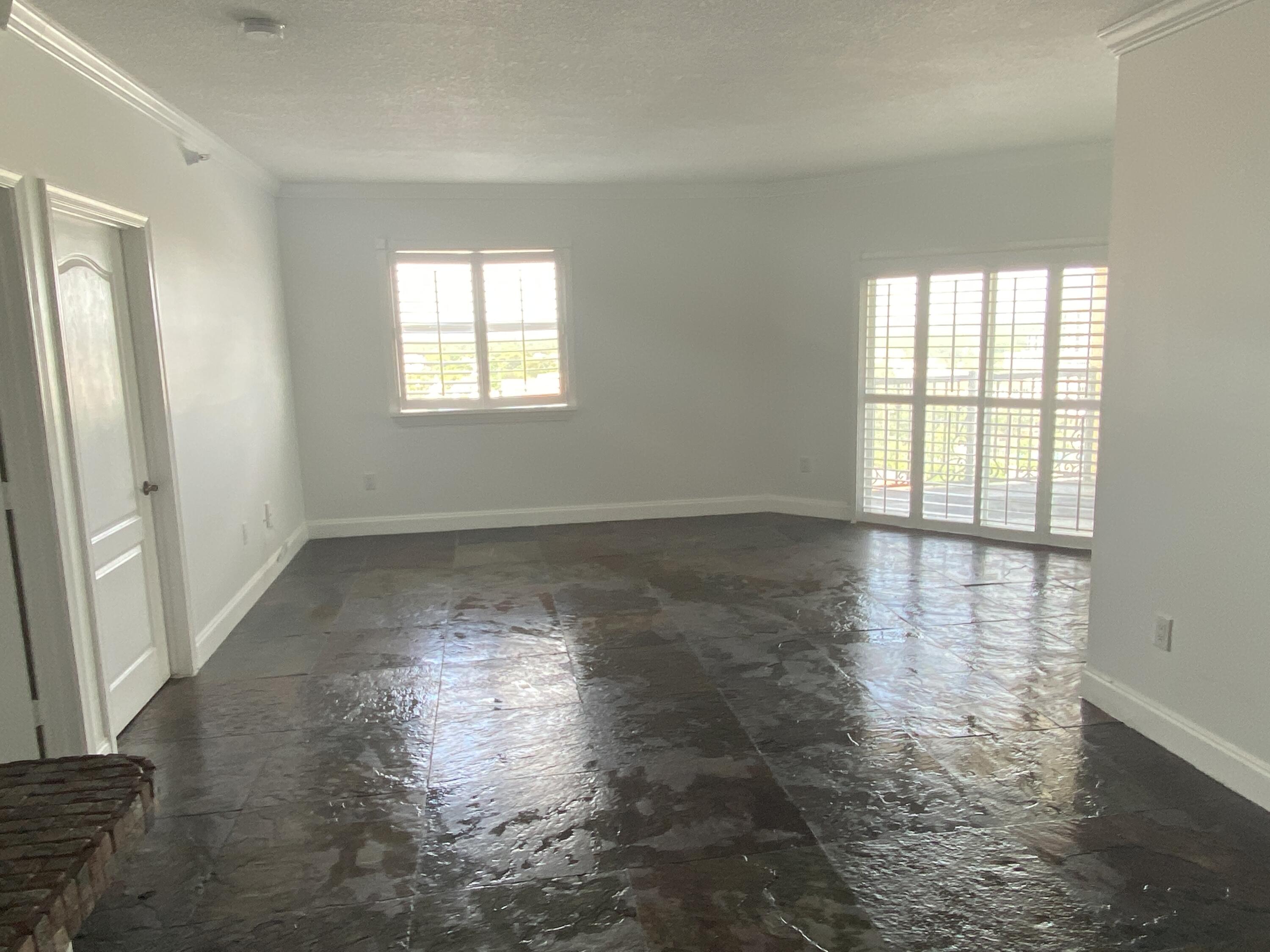 1627 Southwest 37th Avenue, Unit 1003 Miami, FL 33145 - Photo 6 of 12 wooden floor in an empty room with a window