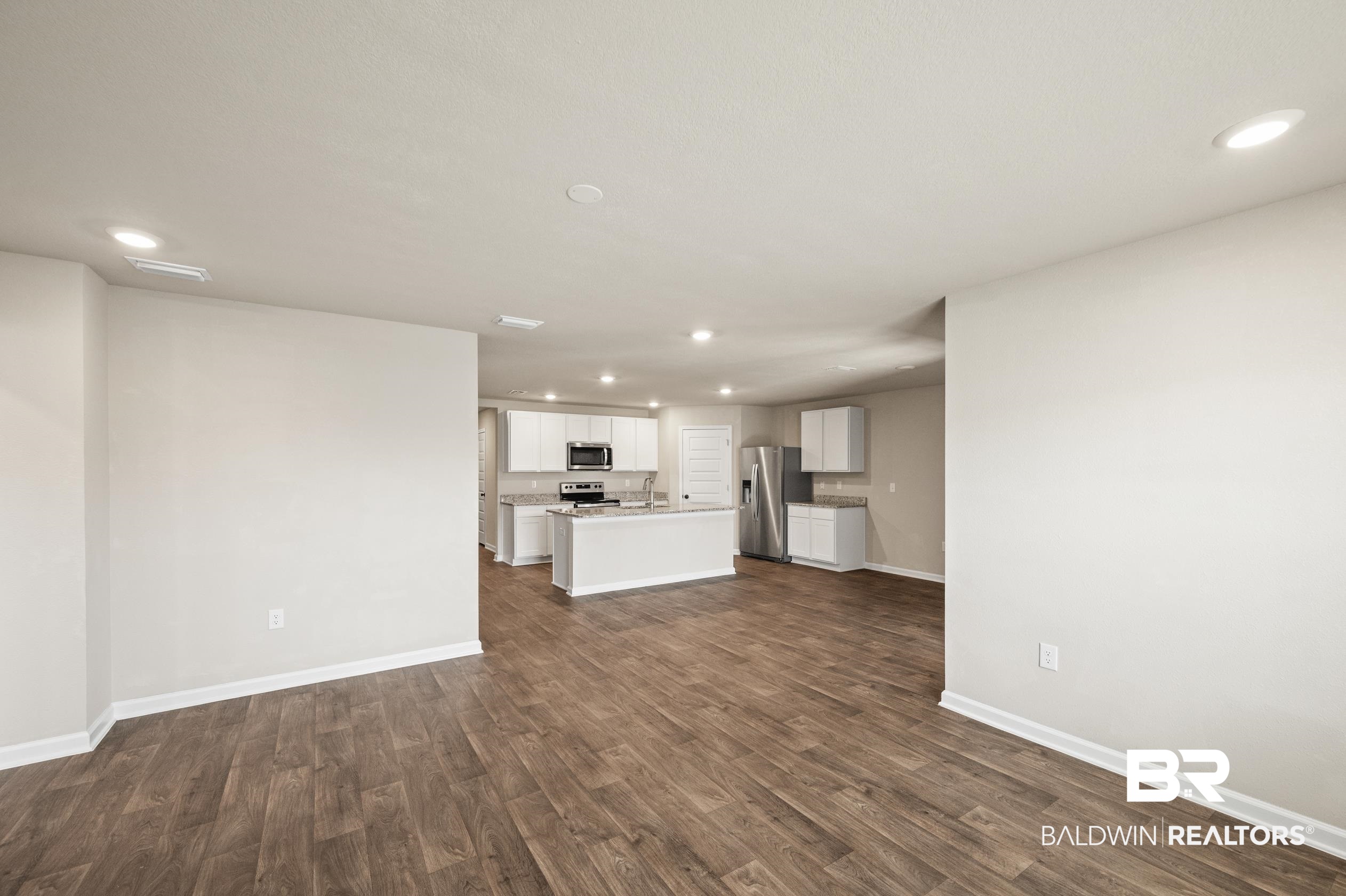 10353 Zenyatta Loop Daphne, AL 36526 - Photo 12 of 33 Unfurnished living room with sink and dark hardwood / wood-style floors