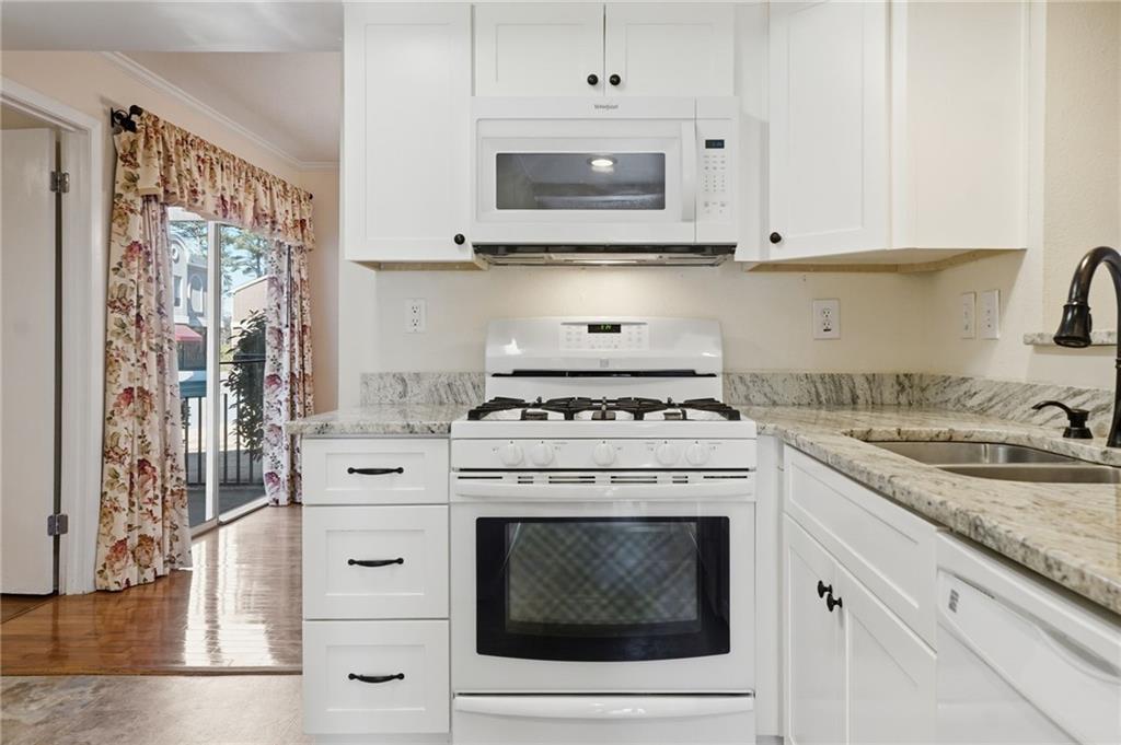 3301 Henderson Mill Road, Unit J1 Atlanta, GA 30341 - Photo 12 of 38 a white stove top oven sitting inside of a kitchen
